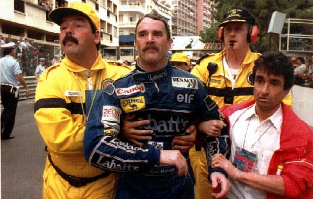 Mansell is assisted by race officials after hunting down, but failing to pass Ayrton Senna in 1992.