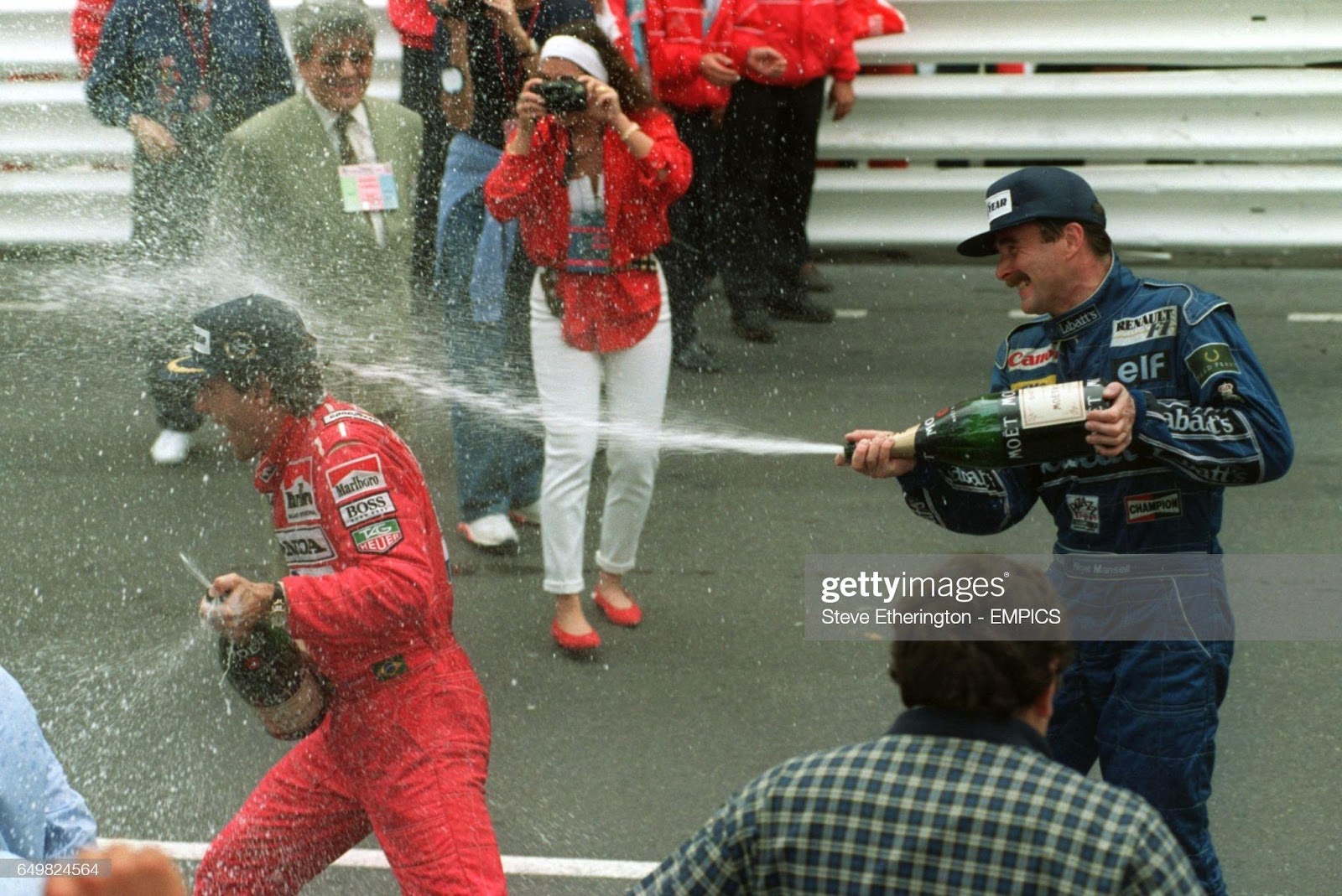 Nigel Mansell soaks Ayrton Senna after race at the 1992 Monaco Grand Prix.
