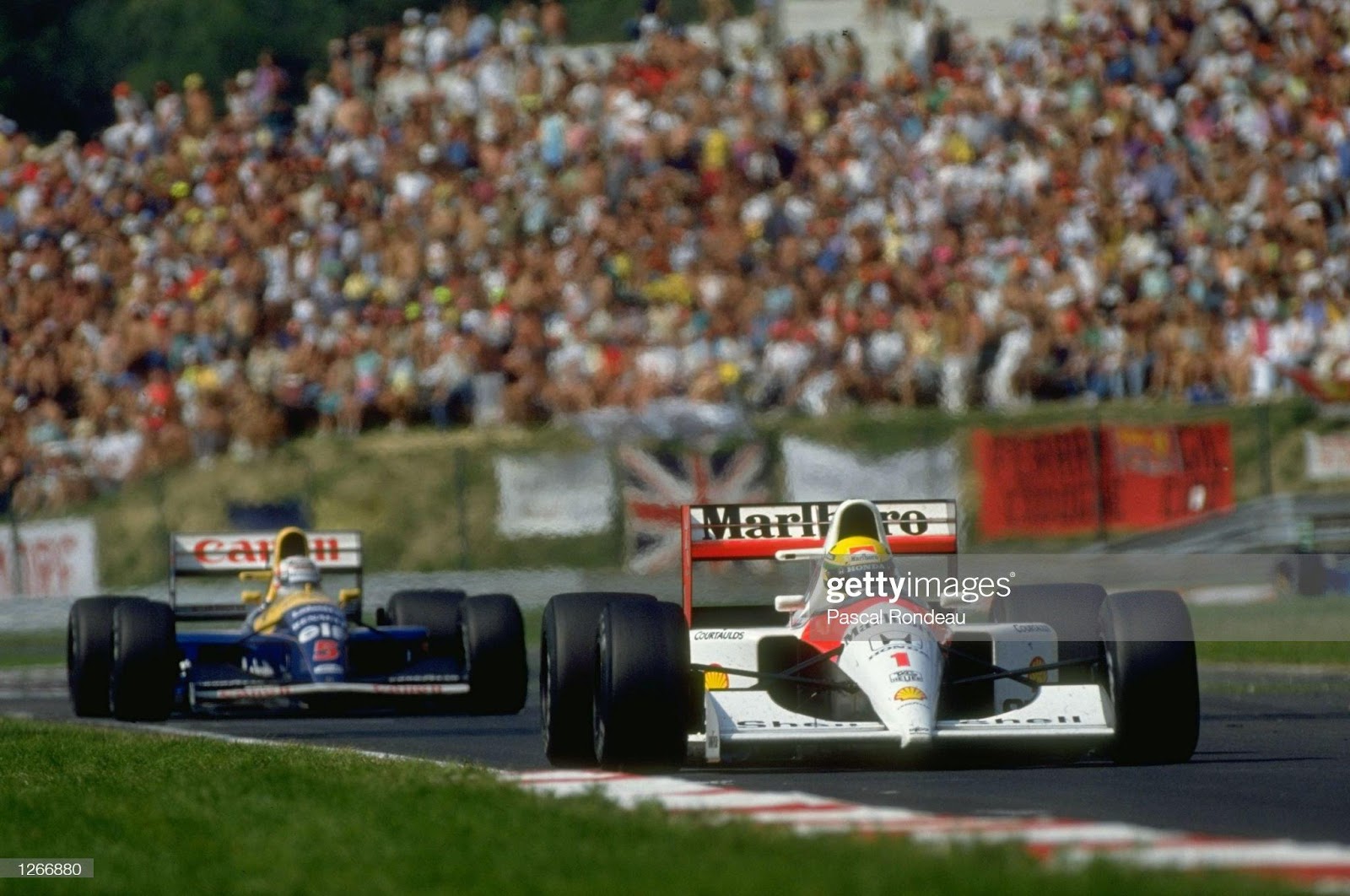 1991: Williams Renault driver Nigel Mansell chases McLaren Honda driver Ayrton Senna to the line during the Hungarian Grand Prix at the Hungaroring circuit in Budapest, Hungary. Senna finished in first place and Mansell in second.