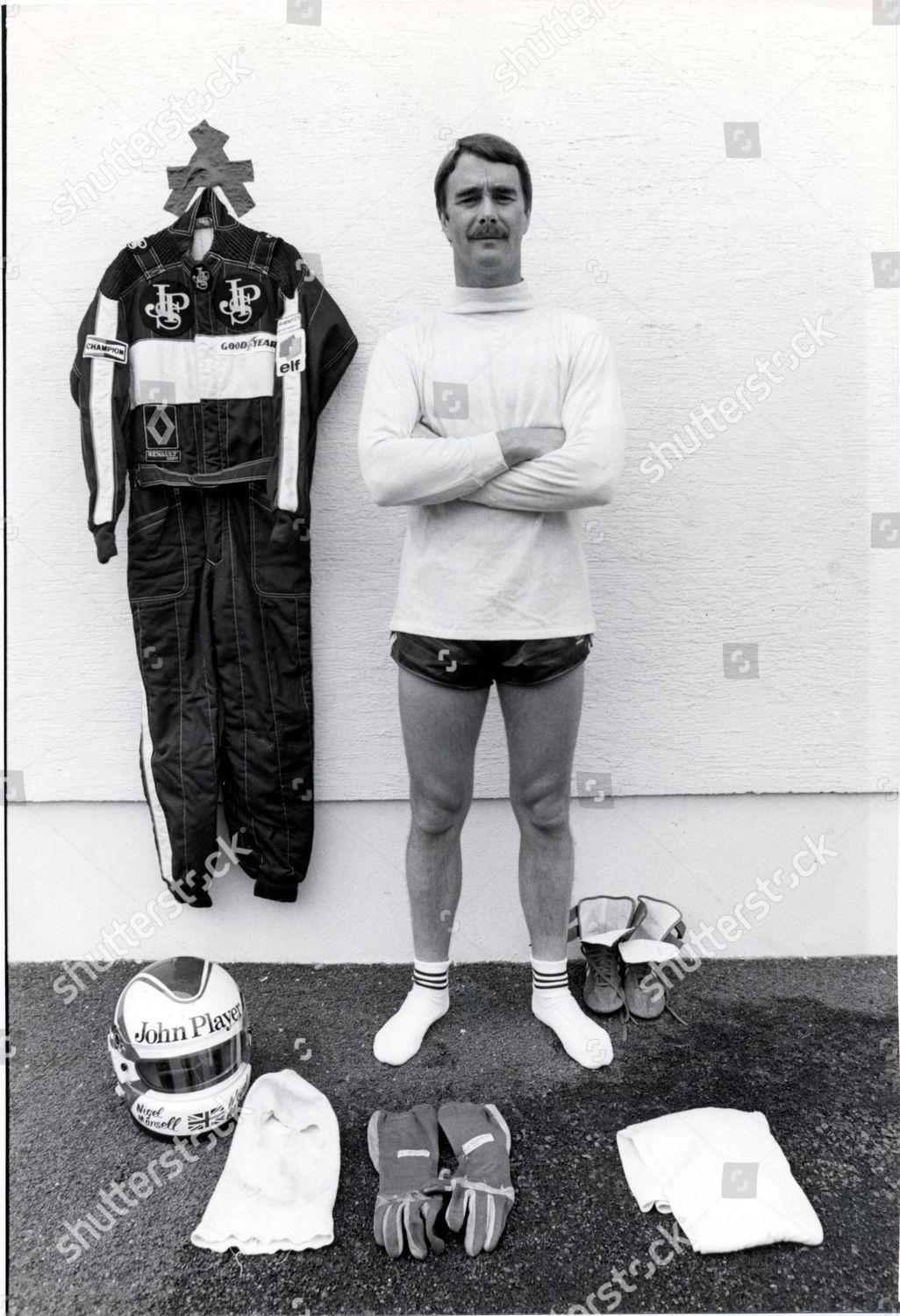Nigel Mansell showing his fireproof racing overalls, boots, underwear, balaclavs, gloves and helmet in 1984.
