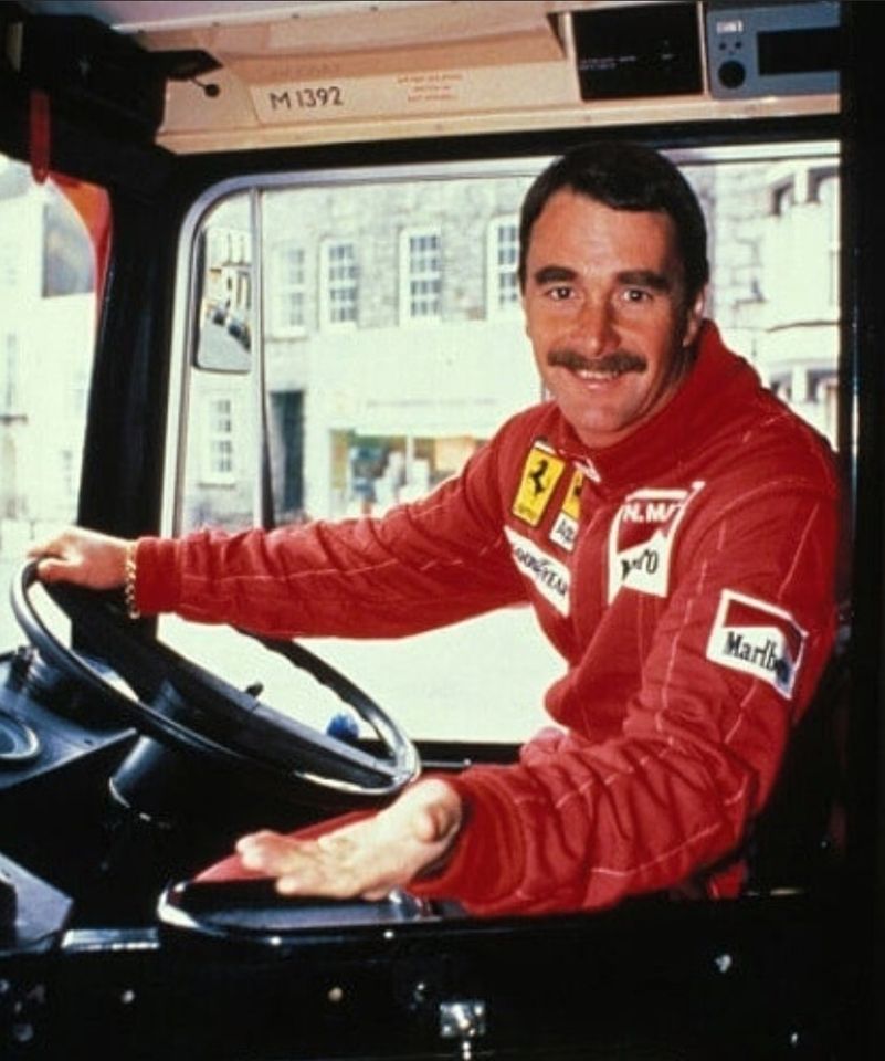 Nigel Mansell poses for a photo opportunity in the driving seat of an Isle of Man bus on 18 April 1989.