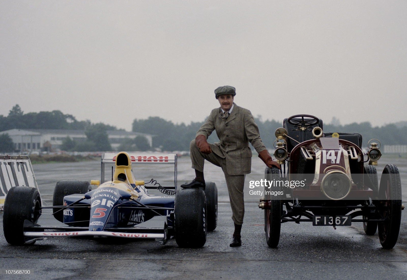 Nigel Mansell, driver of the Canon Williams Renault Williams FW14B Renault 3.5 V10, poses with a 1902 Renault to mark the 85th anniversary of the Brooklands circuit on 9th July 1992 at the Brooklands Circuit in Weybridge, Great Britain.