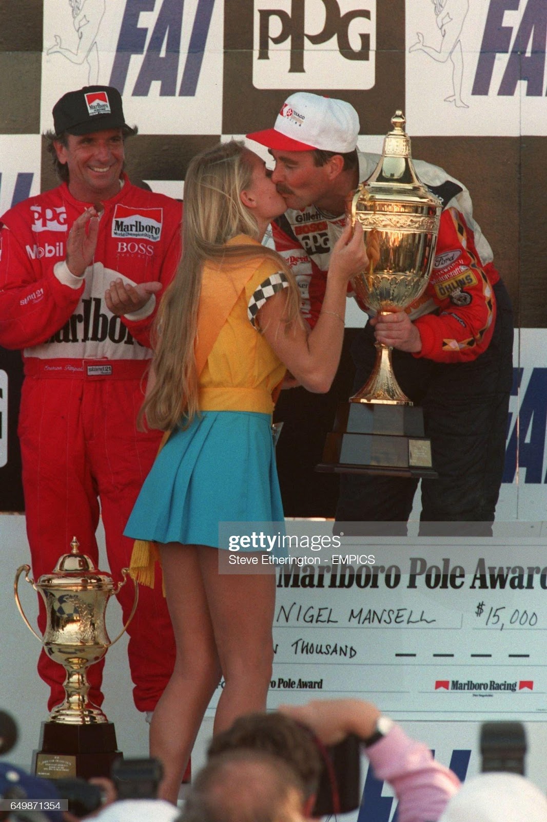 Nigel Mansell receives the winner trophy from Miss Indy car at the 1993 Indy car Australian Grand Prix.