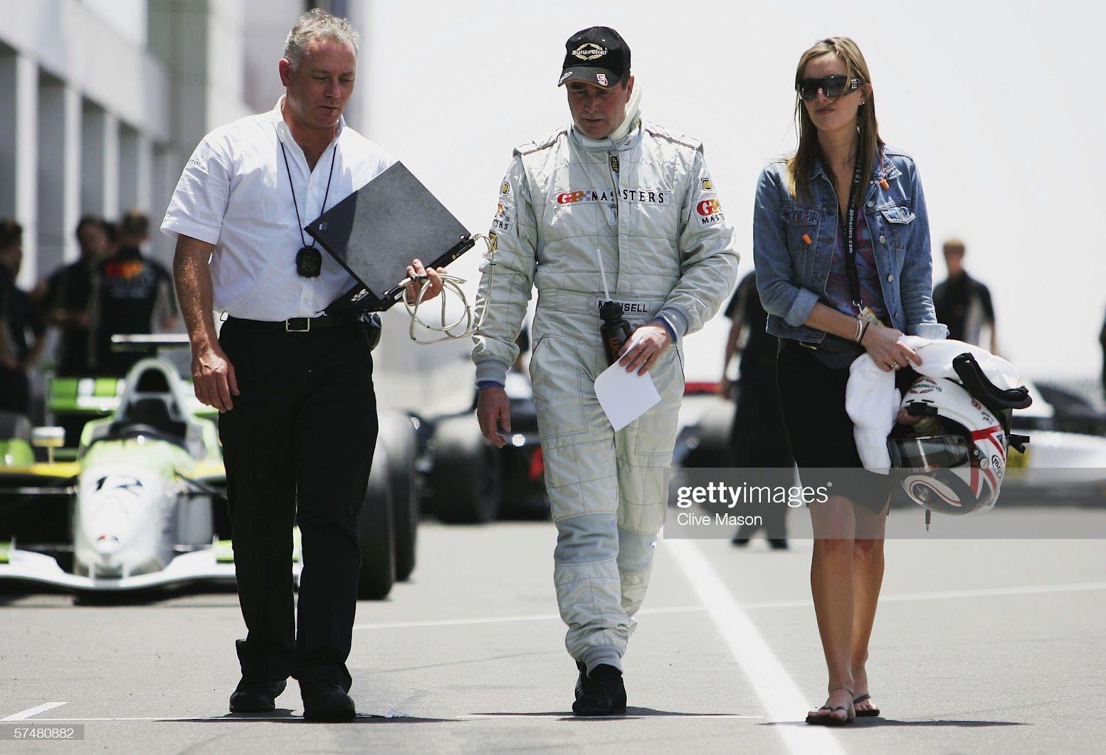 Nigel Mansell walks down the pitlane with his daughter Chloe after third official practice prior to the Grand Prix Masters race at the Losail International Circuit on April 28, 2006, in Doha, Qatar.
