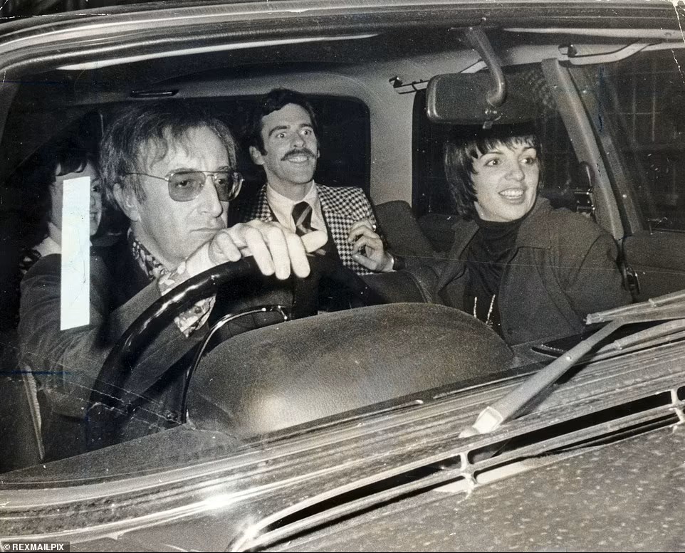 Peter Sellers driving a car sitting next to Liza Minnelli.