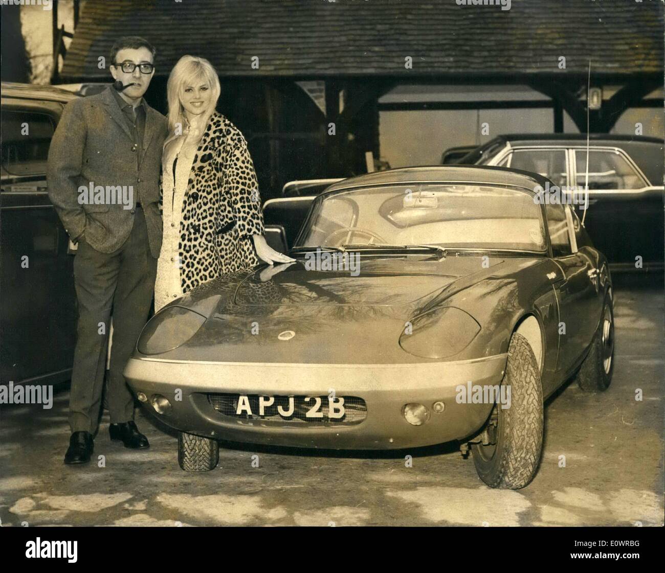 Peter Sellers and Britt Ekland admire the new Lotus car which he bought today as an engagement present for her, at his home at Elstead in Surrey on 02 February 1964.