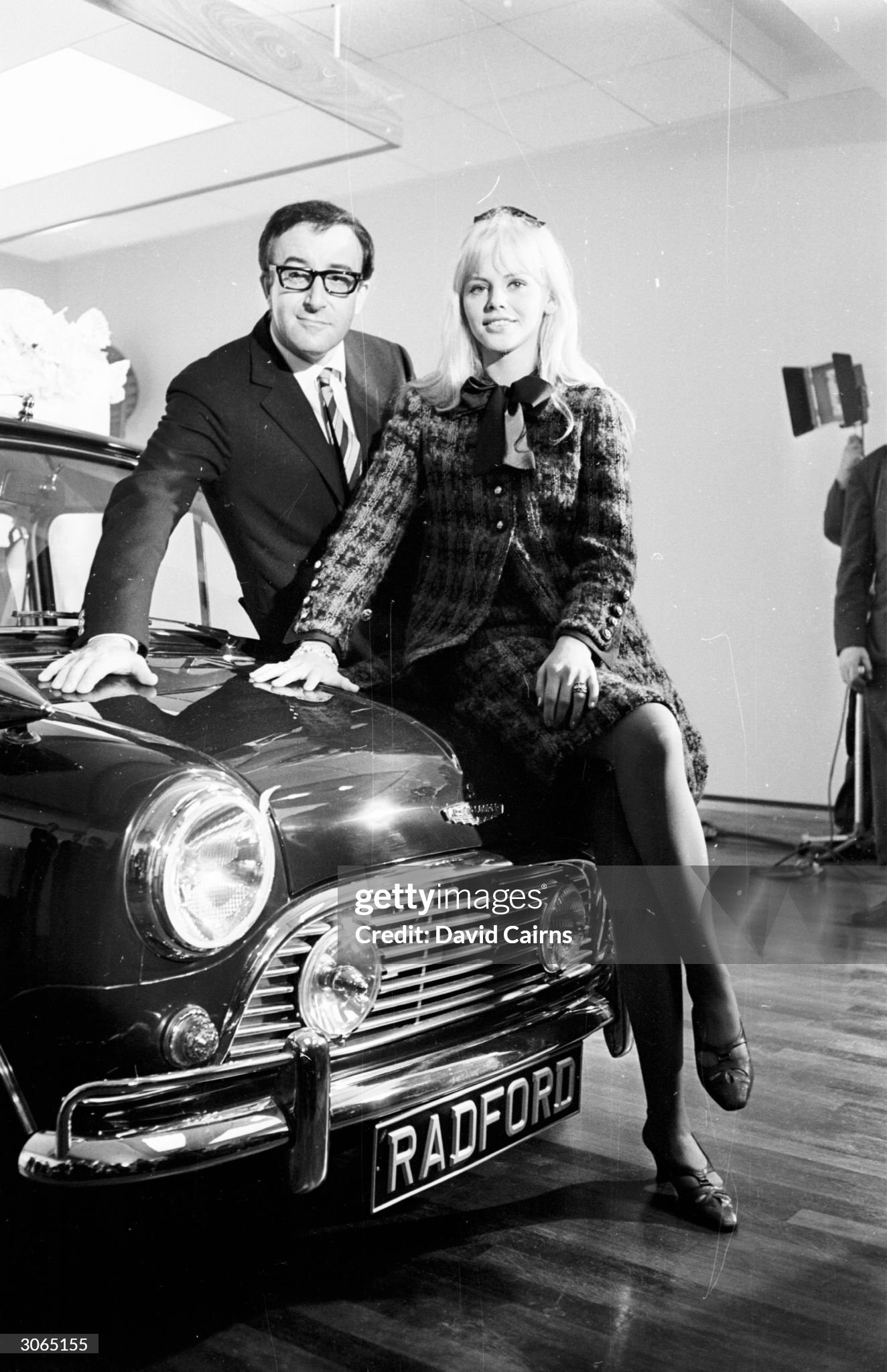 07th October 1965: actress Britt Ekland sitting on the Mini her husband Peter Sellers bought for her birthday, at the Radford Motor Company showroom, Hammersmith, London.