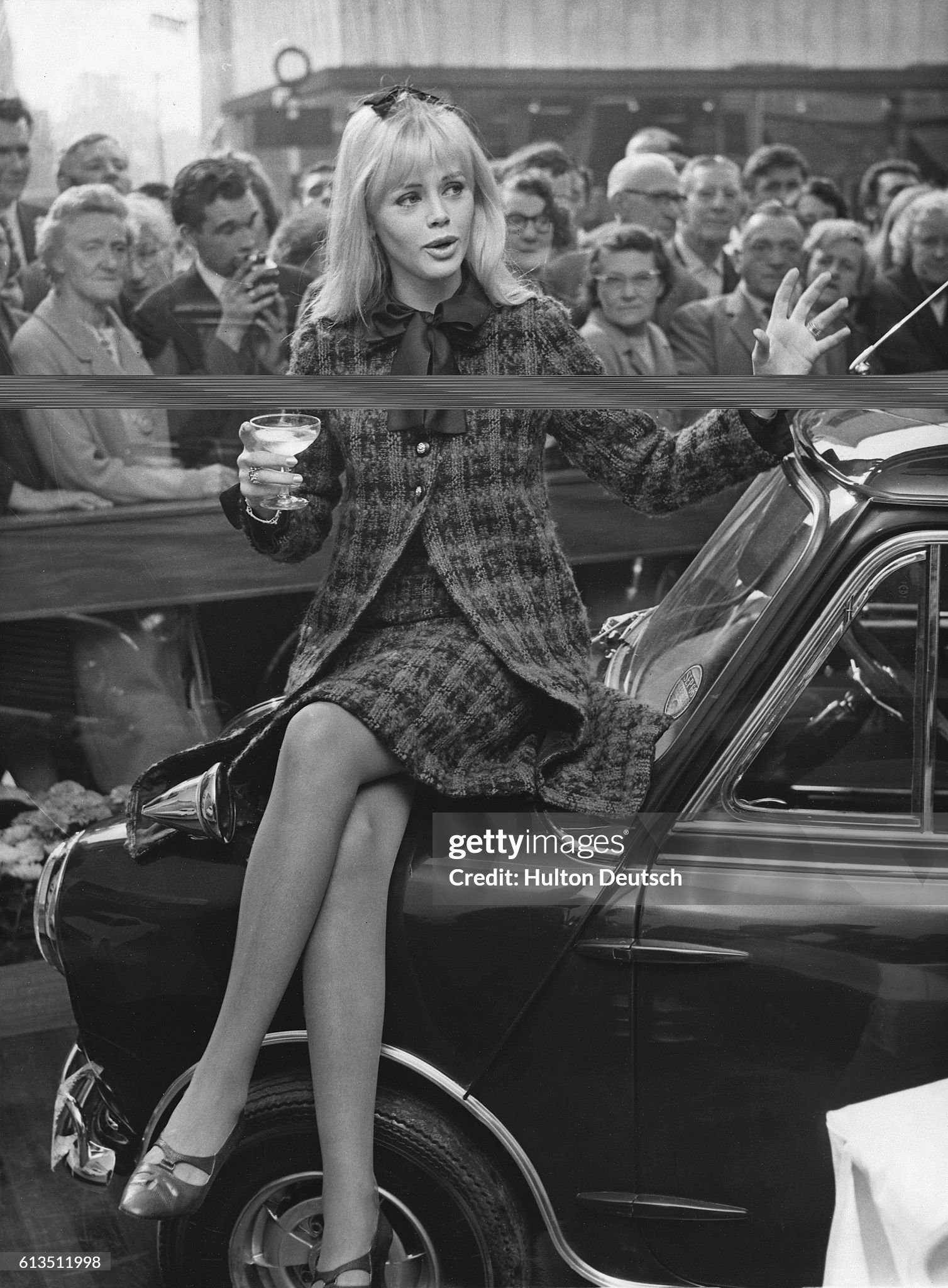 Britt Ekland sits on a 'Mini' presented to her by her husband Peter Sellers, British comic actor, in Hammersmith, London, in 1965.