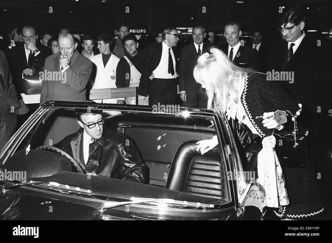 Peter Sellers and Brit Ekland at the British International Motor Show in London on 19 October 1965.
