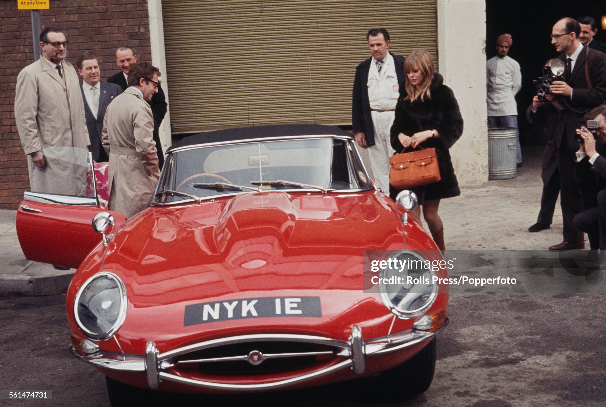 British comedian and actor Peter Sellers presents a gift of a red Jaguar E-Type car to his girlfriend Britt Ekland at Heathrow airport in London on 13th March 1967.