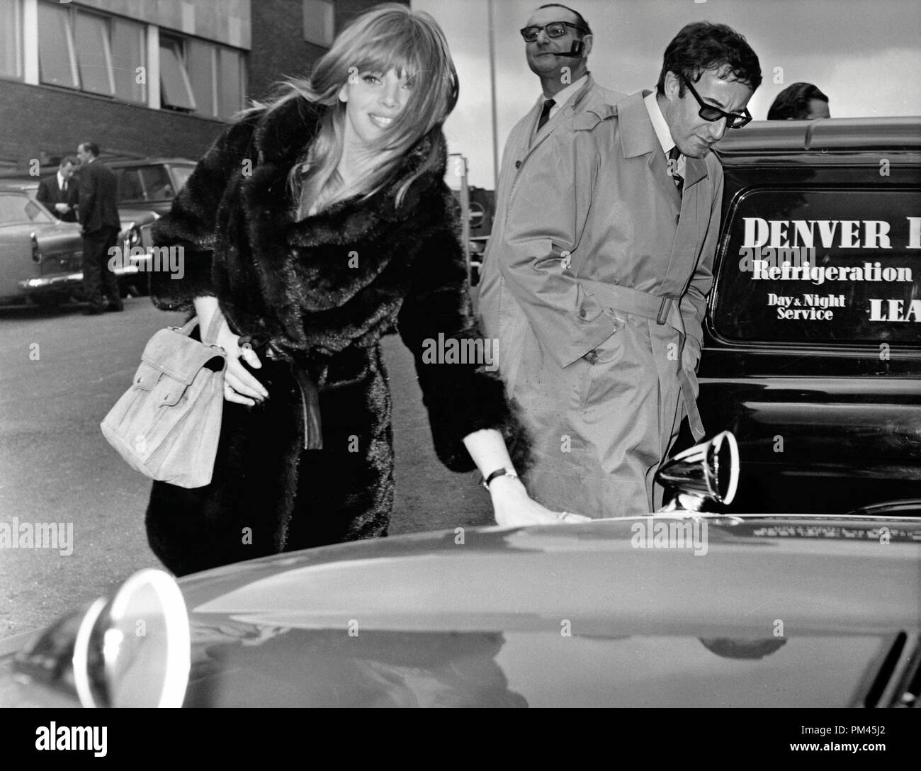 British comedian and actor Peter Sellers presents a gift of a red Jaguar E-Type car to his girlfriend Britt Ekland at Heathrow airport in London on 13th March 1967.