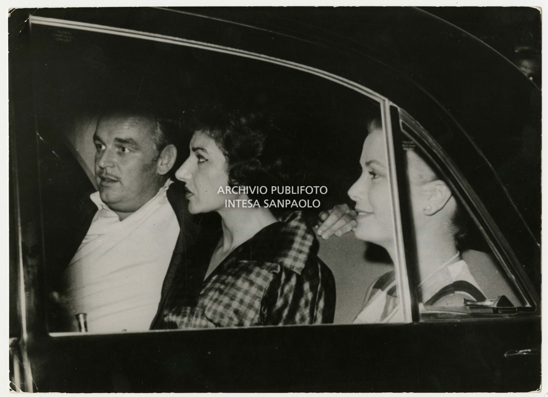 Grace Kelly in a car, accompanied by Maria Callas and Prince Rainier III of Monaco, in Palermo on 13 September 1960.