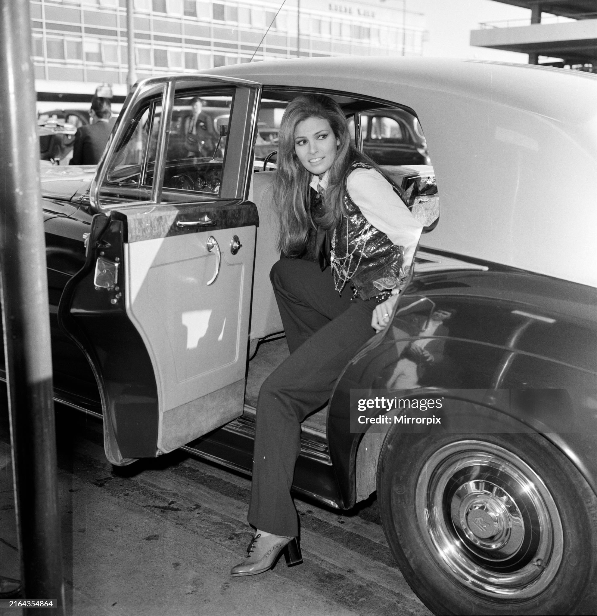 Film star Raquel Welch at Heathrow airport, getting out of a Rolls Royce Silver Cloud. 