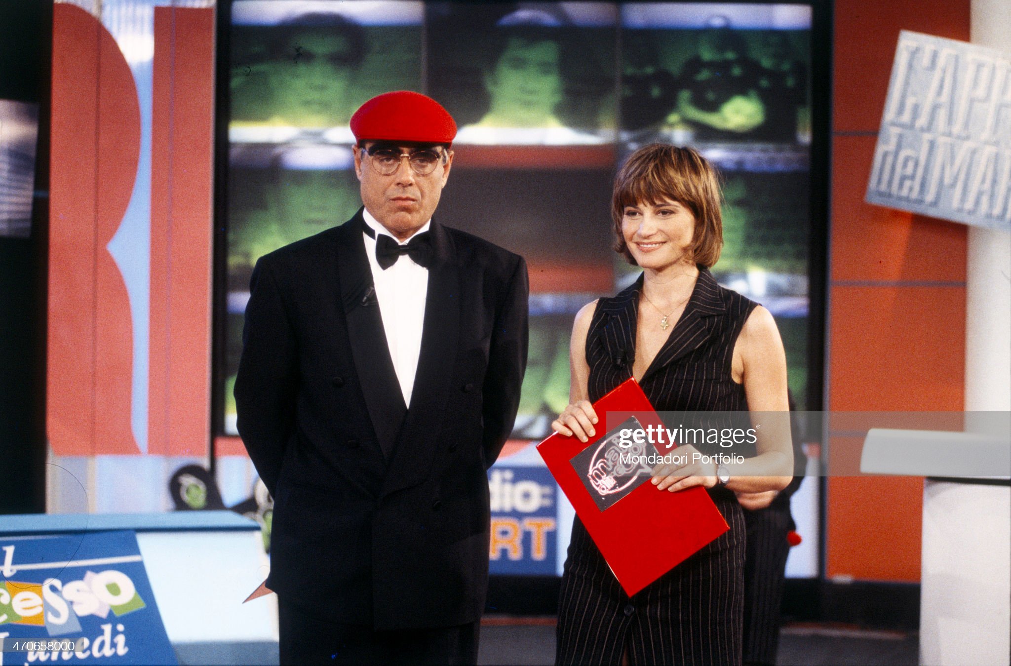 Comedian Teo Teocoli, in the guise of AC Milan supporter Peo Pericoli, conducts the sport/comical broadcasting ‘Mai dire Gol’, together with showgirl Simona Ventura; both listen silent the voiceover of the authors, the Gialappa's Band trio, in 1994 in Cologno Monzese, Milano, Italy. 