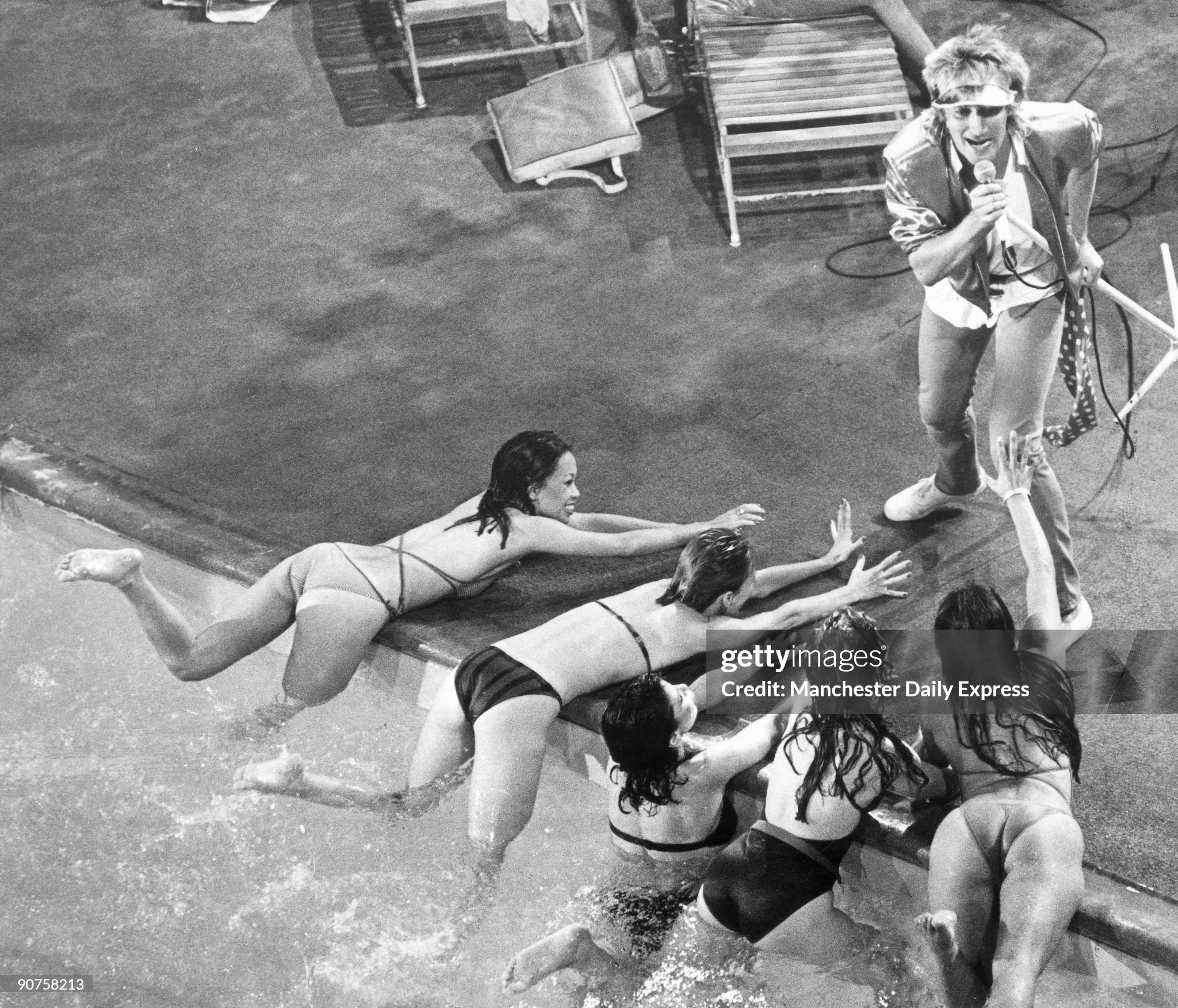 Stewart performs at a hotel swimming pool during the shooting of the video for ‘Tonight I’m Yours’, his latest single, at Los Angeles in October 1981. 