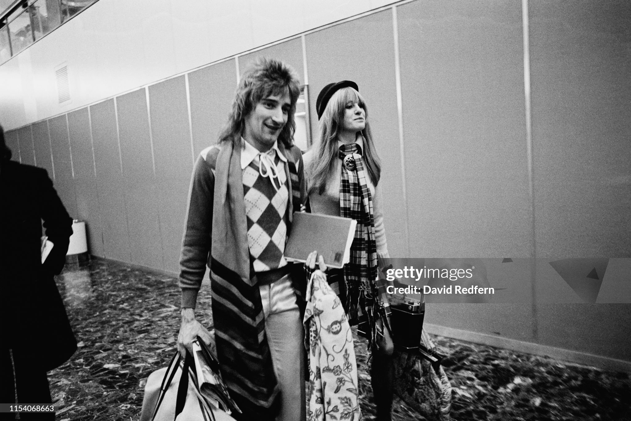 Rod Stewart with an unidentified woman at Heathrow Airport, London, UK, in 1973. 