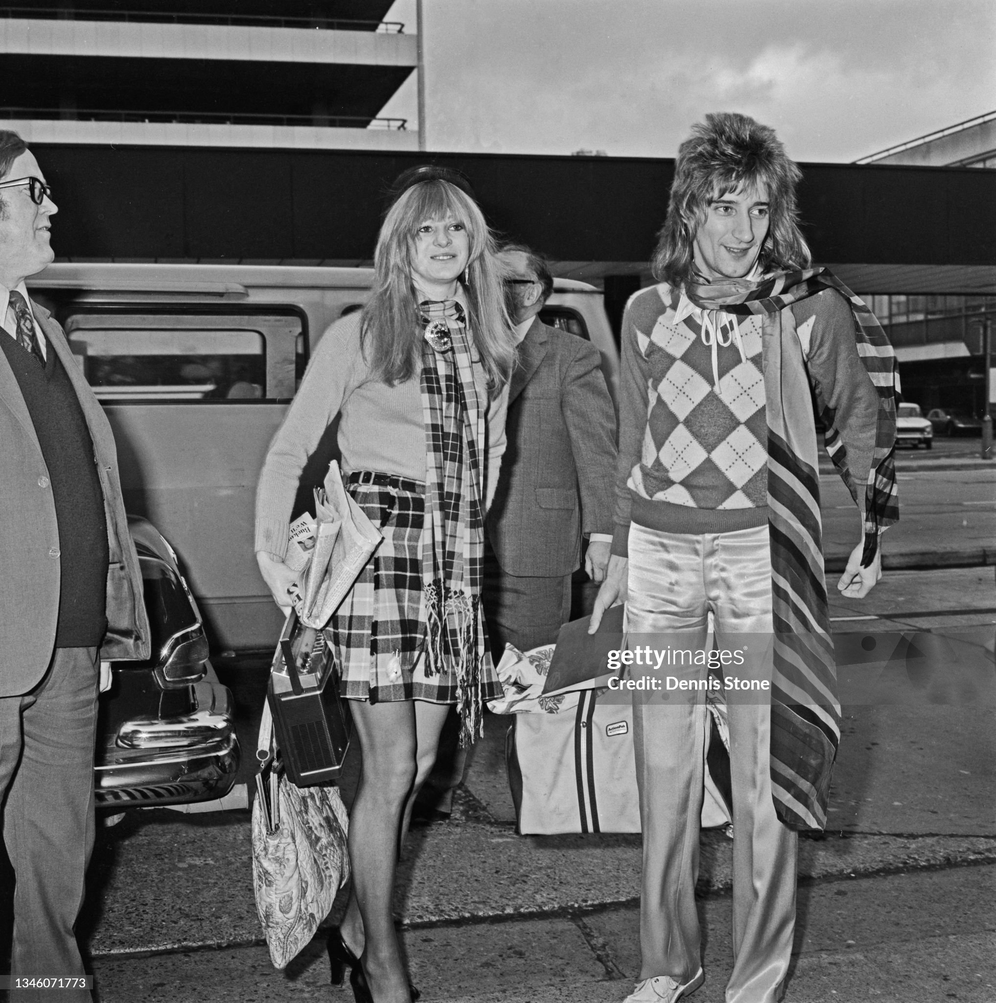 Rod Stewart with his partner Dee Harrington at Heathrow airport in London, UK, on 24 January 1974.