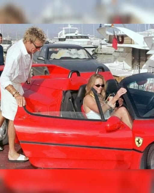 Sir Rod Stewart opening the door of his Ferrari F50 in Marbella, Spain. 