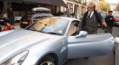 Rod Stewart getting into a Ferrari California.