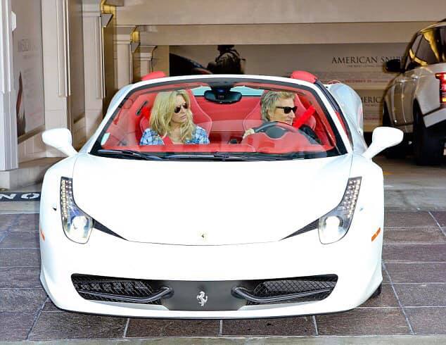 Rod Stewart and his wife in his white Ferrari 458.