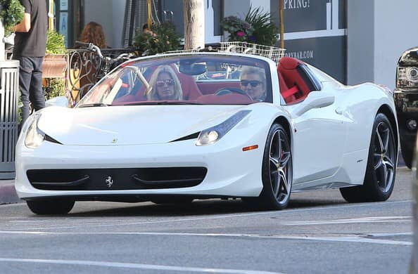 Rod Stewart and his wife in his white Ferrari 458.