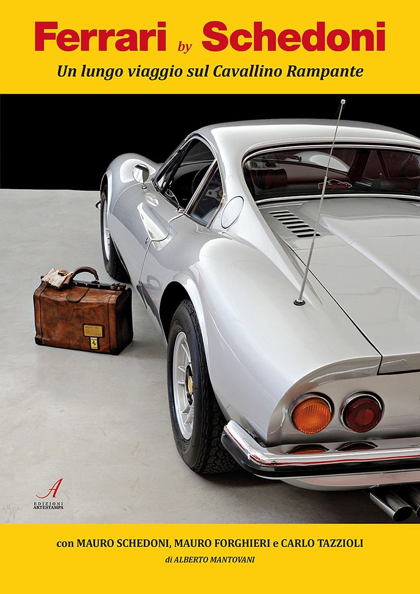 A gray Ferrari Dino and a suitcase produced by Schedoni.