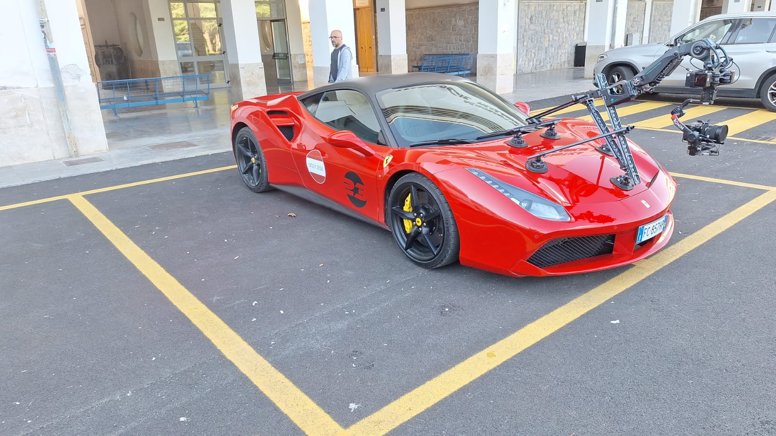 A Ferrari with video shooting equipment mounted on the hood.