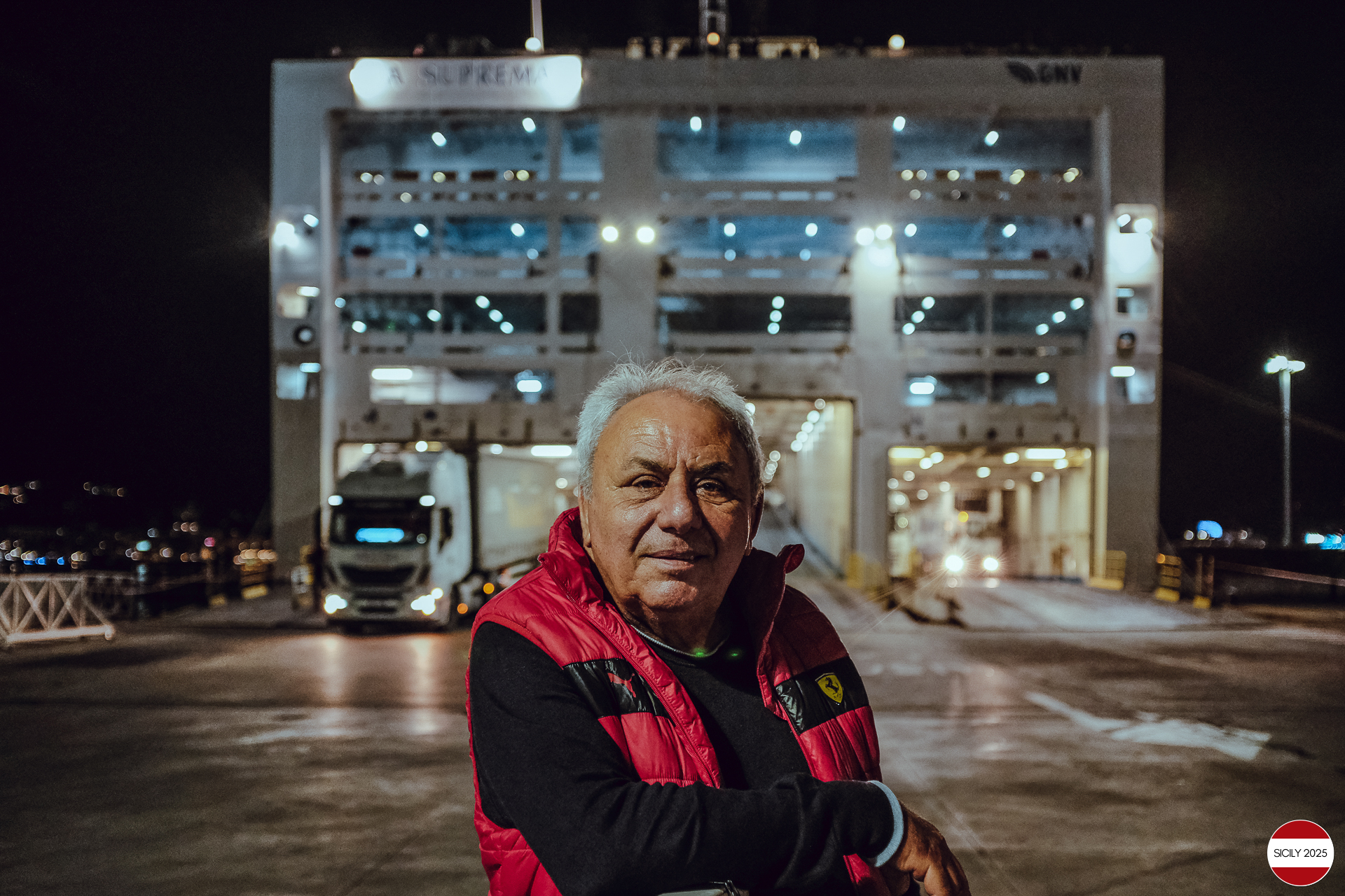 A Ferrari driver in front of the ship during the boarding of the cars. 
