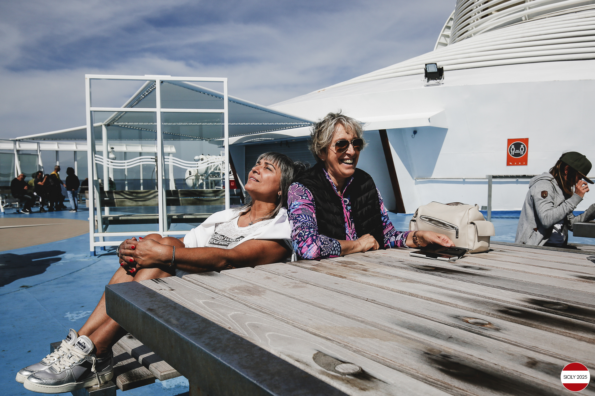 Ferrari drivers and their partners relax on the ship as it sails towards Palermo. 