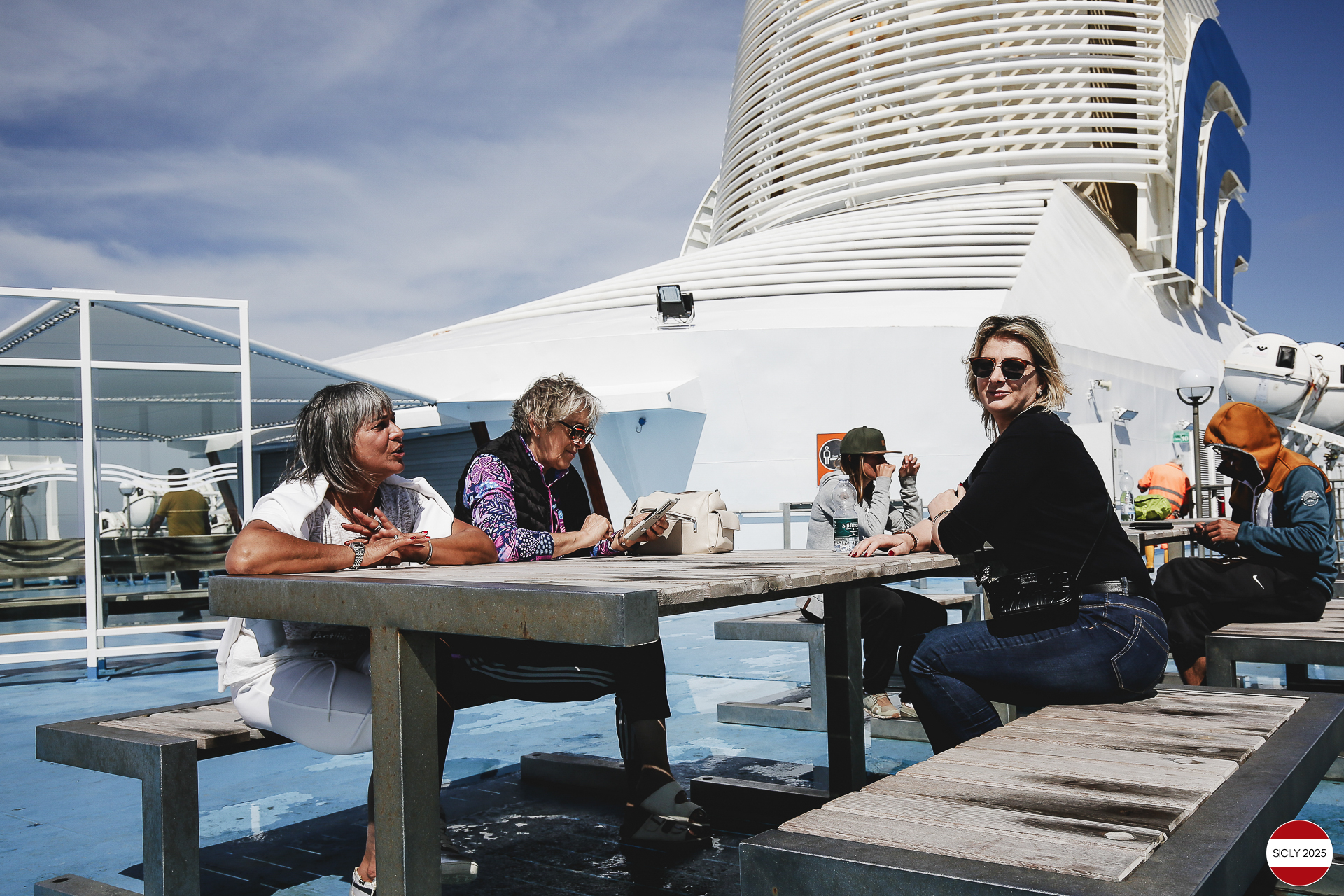 Ferrari drivers and their partners relax on the ship as it sails towards Palermo. 