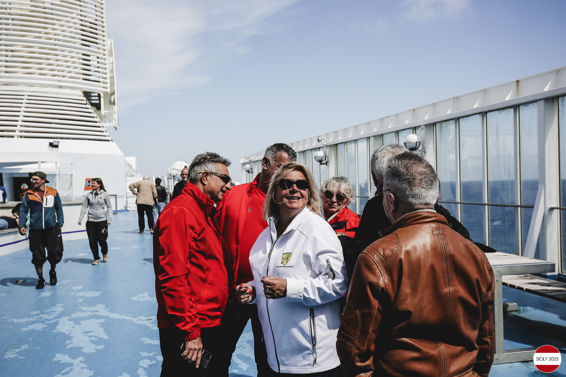 Ferrari drivers and their partners relax on the ship as it sails towards Palermo. 