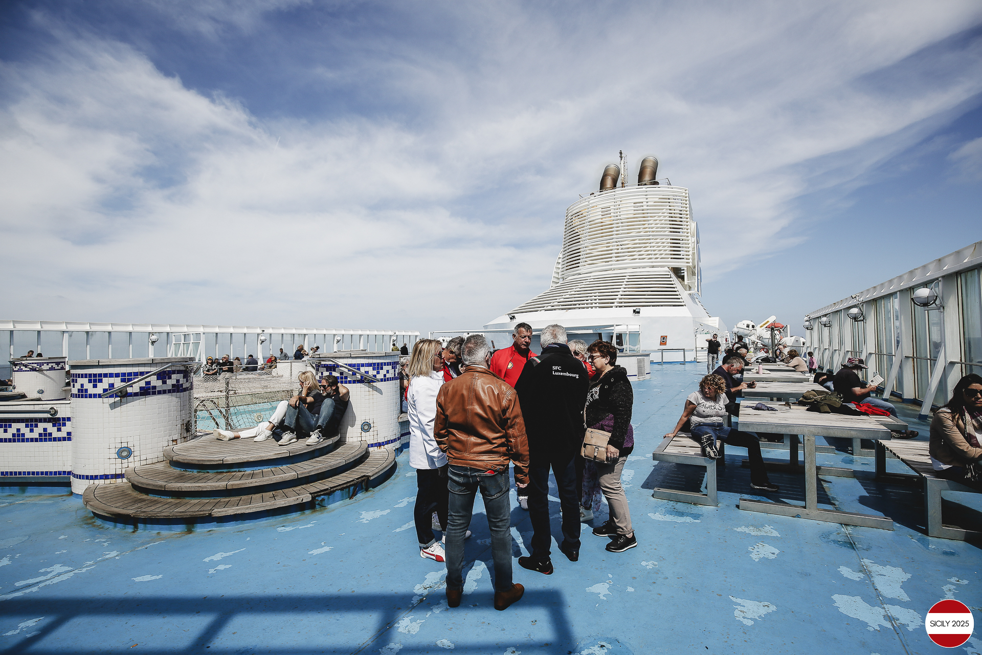 Ferrari drivers and their partners relax on the ship as it sails towards Palermo. 