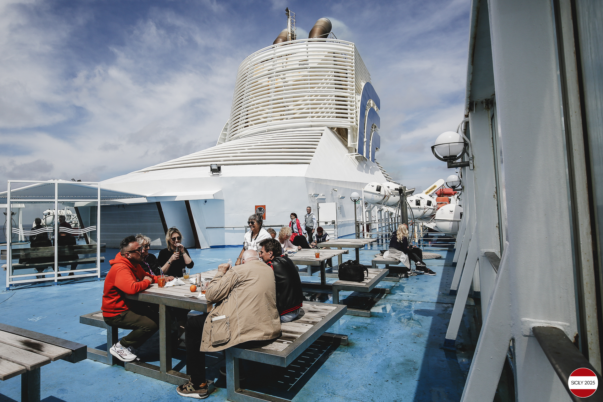 Ferrari drivers and their partners relax on the ship as it sails towards Palermo.