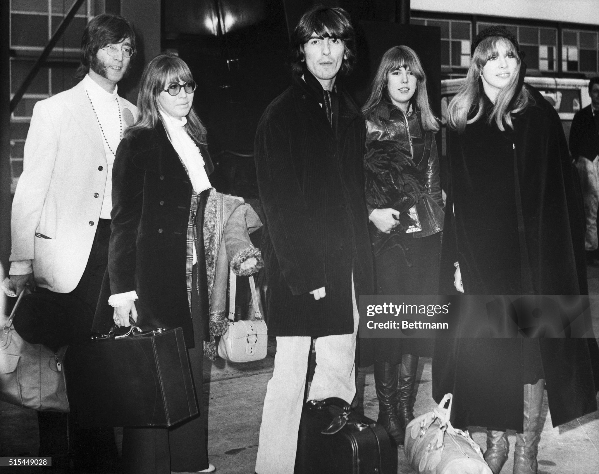 John Lennon and George Harrison shown at London (Heathrow) Airport with their wives Cynthia (next to John) and Pattie (right) on 15 February 1968. 