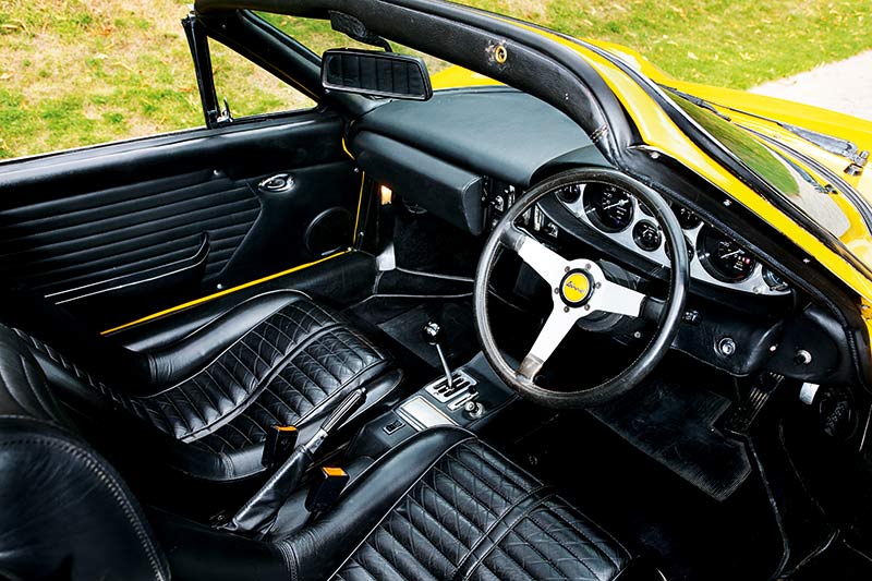 The interior of a yellow Ferrari Dino.