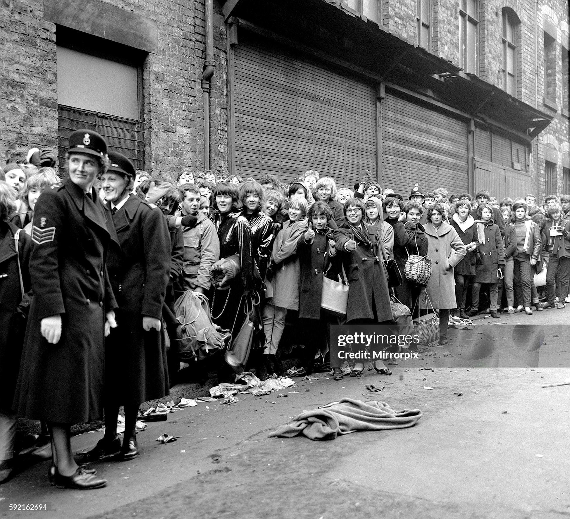 Policemen and women help to keep the teenagers back while queueing for tickets for the Beatles at Liverpool Empire Theatre in November 1963. 