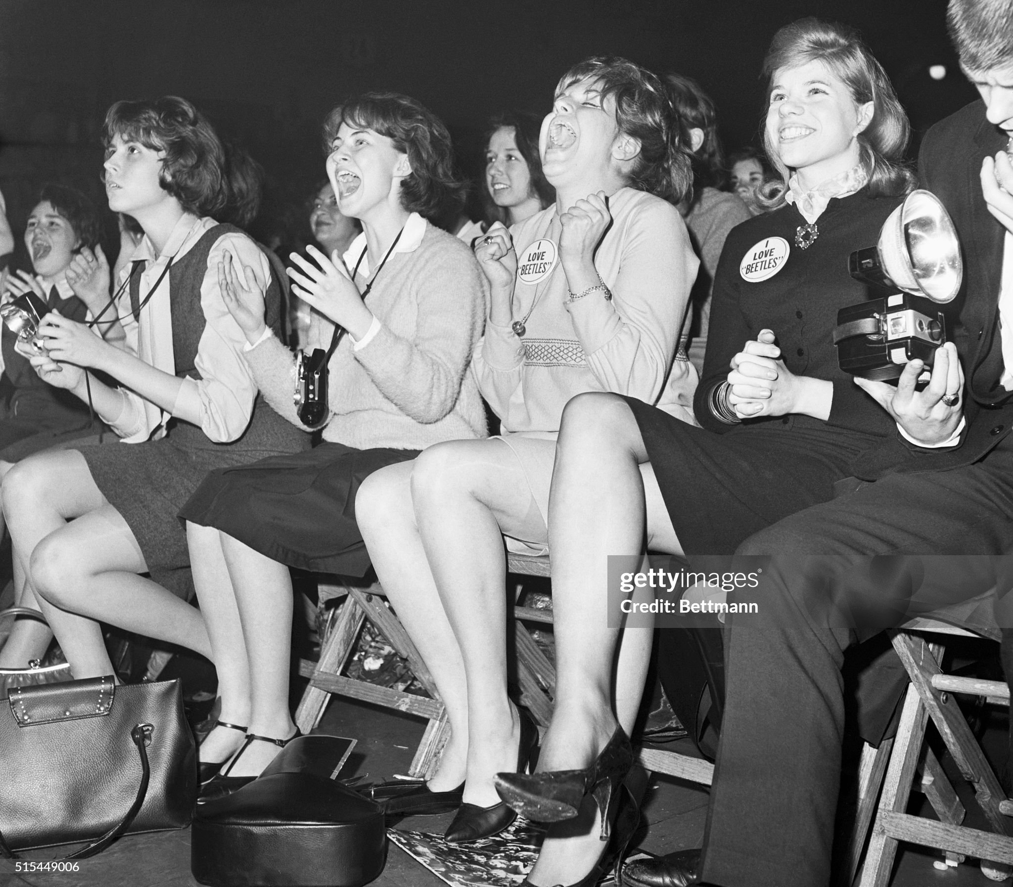 Teenage girls scream with enthusiasm as they watch their heroes, The Beatles, perform at the Washington, DC Coliseum in February 1964.