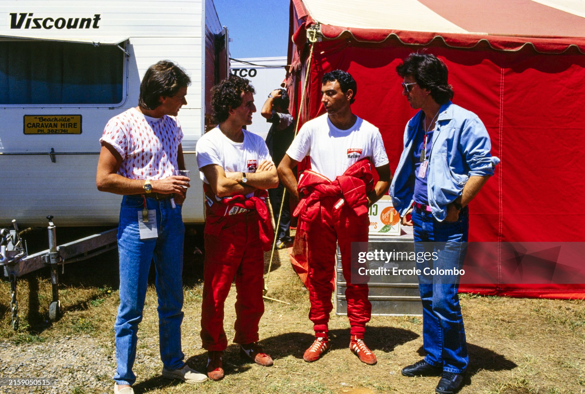 Michele Alboreto poses with Barry Sheene and George Harrison during the Australian Grand Prix at Adelaide Street Circuit on 03 November 1985. 