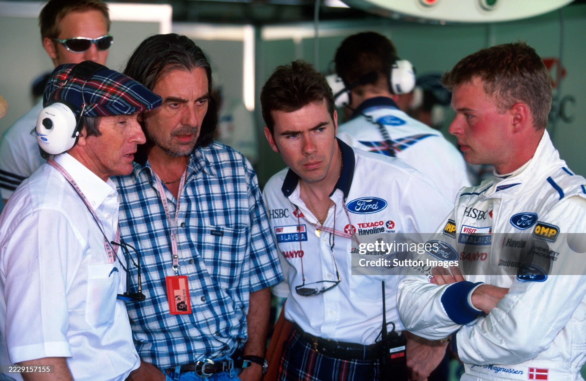 George Harrison visits the Stewart team, Jackie Stewart, Paul Stewart and Jan Magnusson, at the Australian Grand Prix in Melbourne on 09 March 1997.
