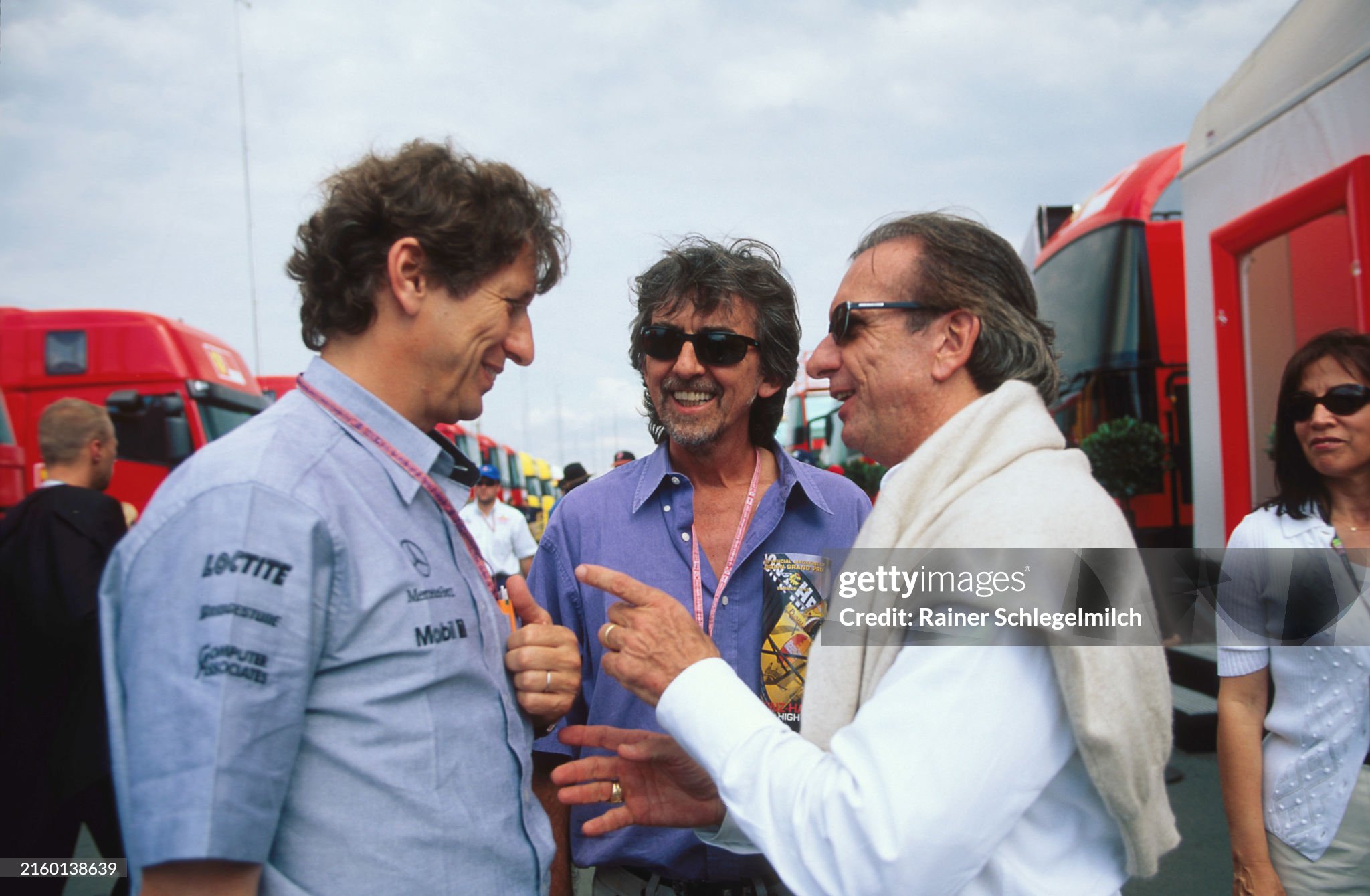 Mario Illien, George Harrison and Emerson Fittipaldi in the paddock during the British Grand Prix at Silverstone on 11 July 1999. 