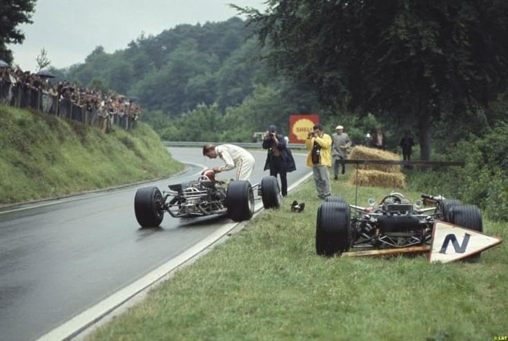 French Grand Prix on July 07, 1968. After retiring, Graham Hill donates his visor to teammate Jo Siffert.