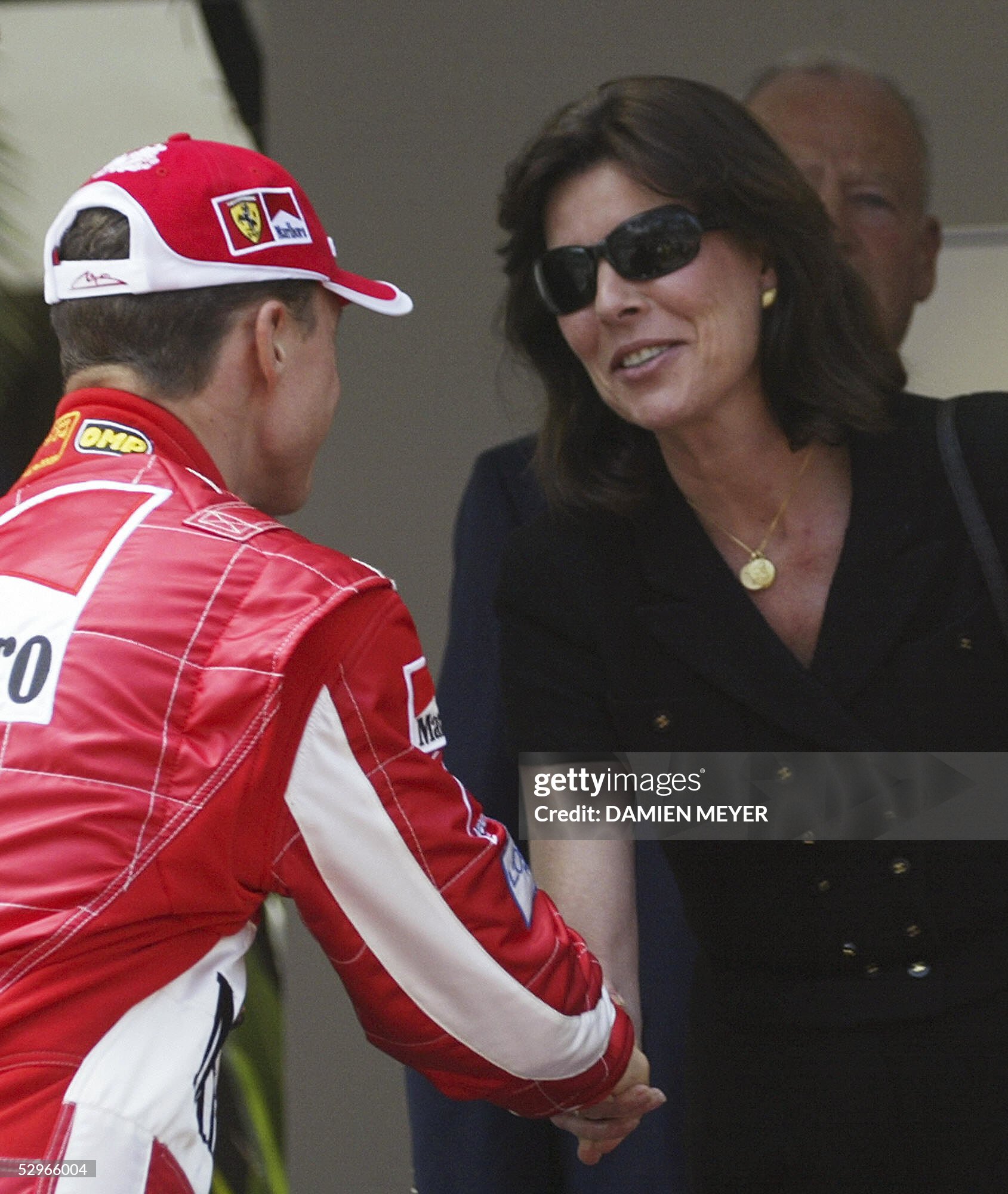 Princess Caroline of Monaco shakes hand with Ferrari German driver Michael Schumacher after a minute of silence in memory of Prince Rainier III, on the start grid of the Monaco racetrack before the start of the Monaco Grand Prix on 22 May 2005. 