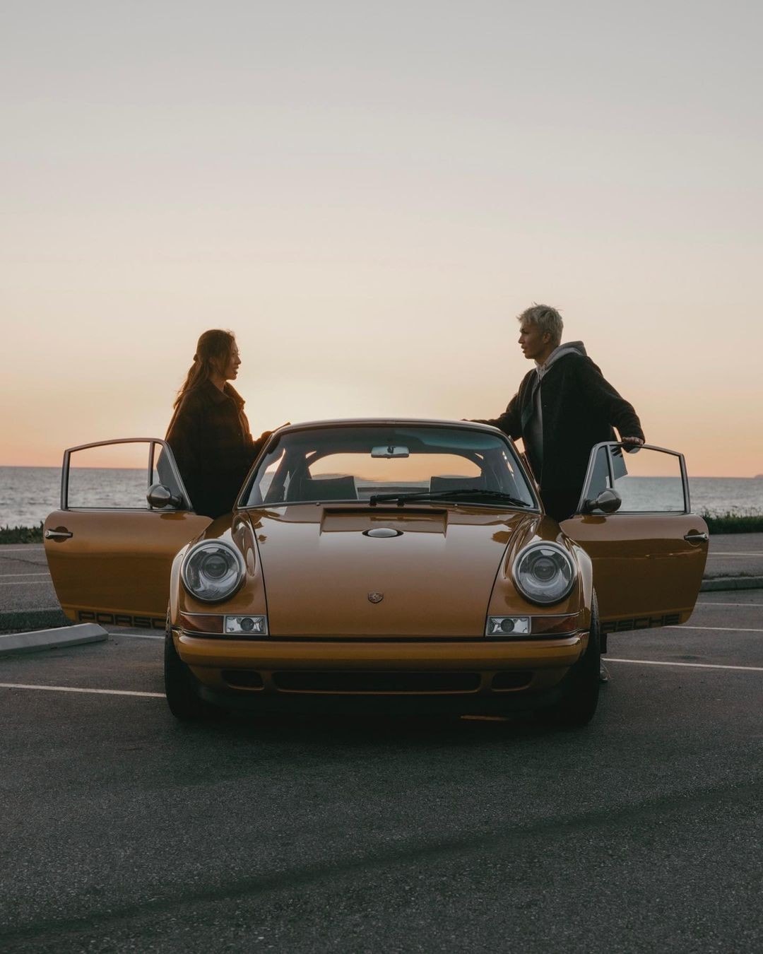 Alex Albon and his girlfriend with his Porsche 911.