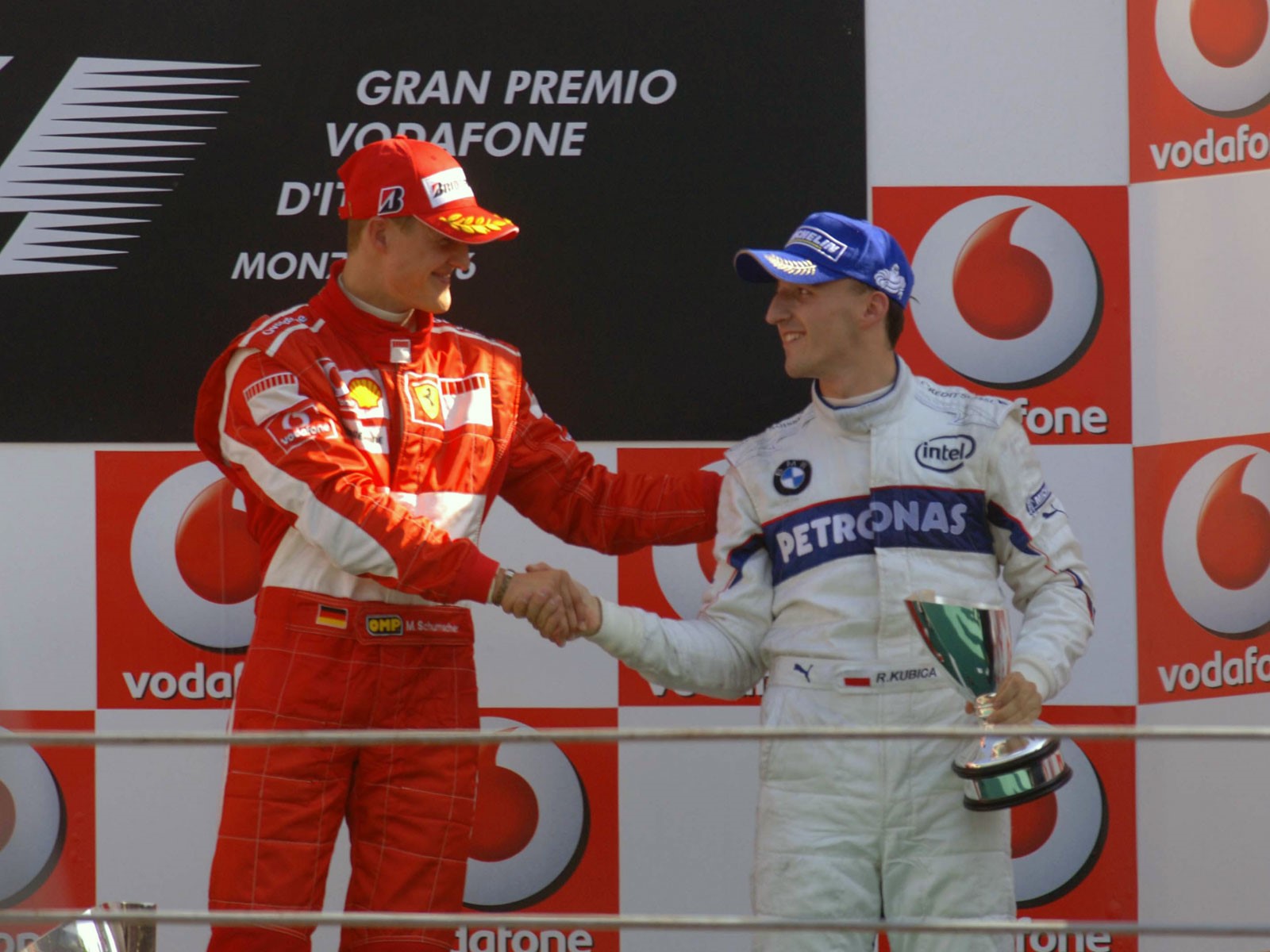 Robert Kubica on the podium with Michael Schumacher.