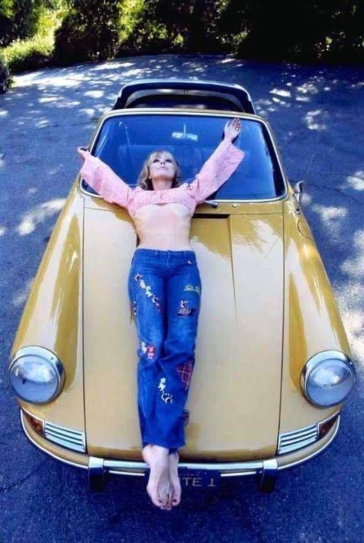 A girl on a Porsche.