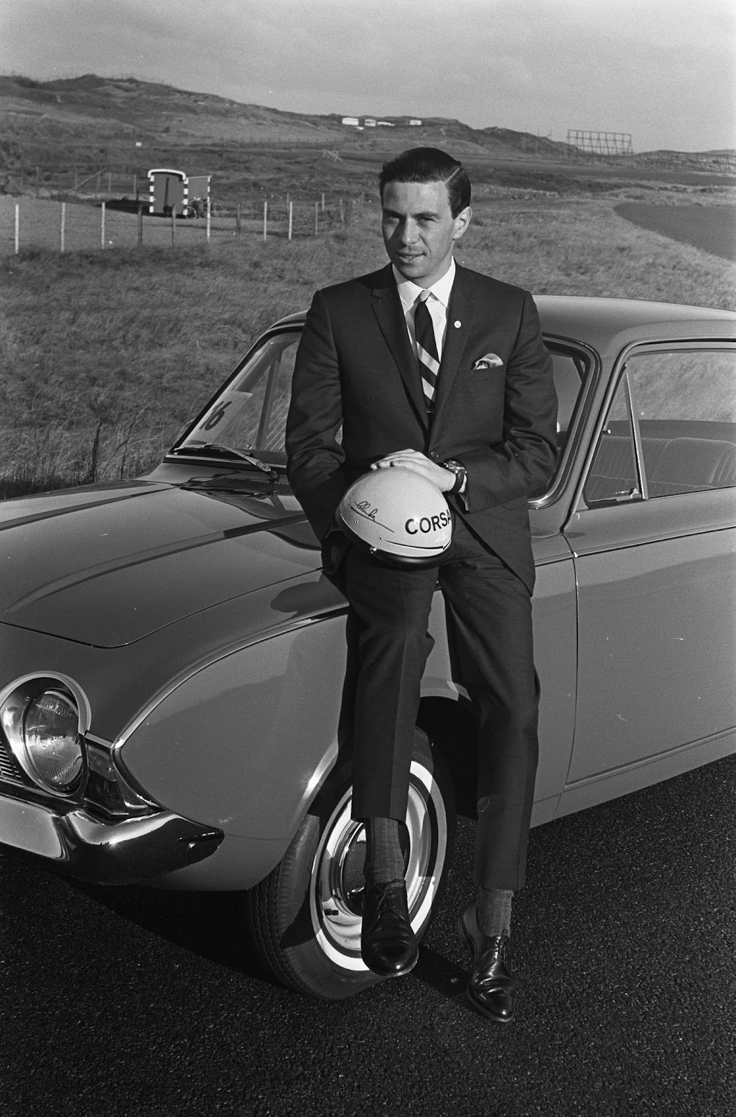 Jim Clark sitting on a car.