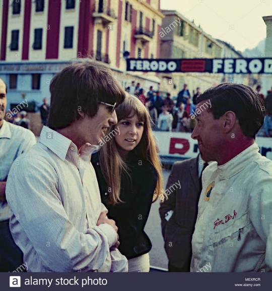 Beatle George Harrison and Patricia Anne Pattie Boyd visiting Monte Carlo and talking to F1 racing driver Jim Clark, 22nd May 1966.