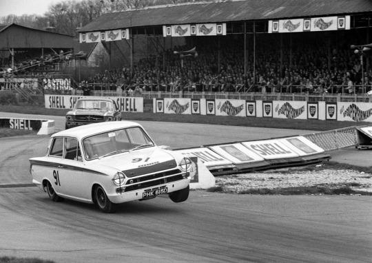 Jim Clark, Ford Lotus Cortina, ahead of Jack Brabham, Alan Brown Ford Mustang, at the 1966 St Mary's Trophy in Goodwood.