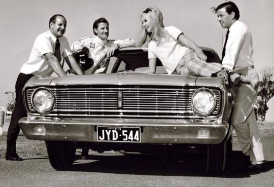 A blondie top model surrounded by champions Denny Hulme, Graham Hill and Jim Clark at Melbourne in 1968.