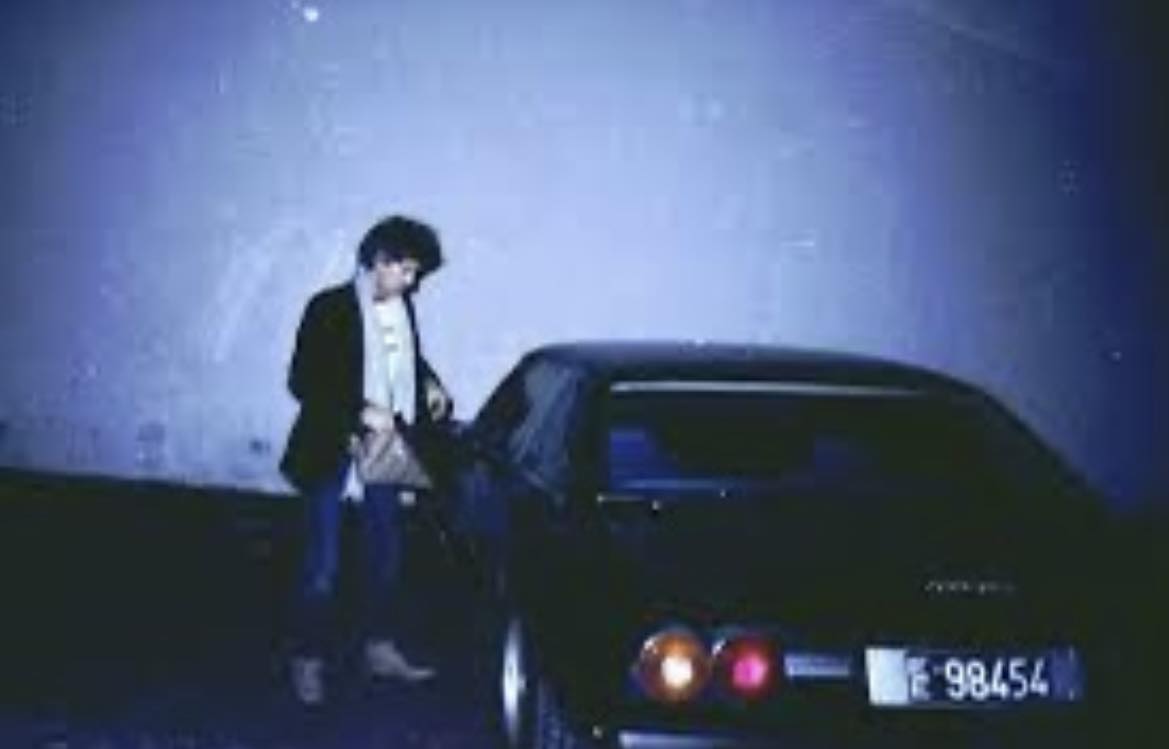 Keith Richards with his Ferrari 400i outside Pathé Marconi Studios in Paris, France, in 1985.